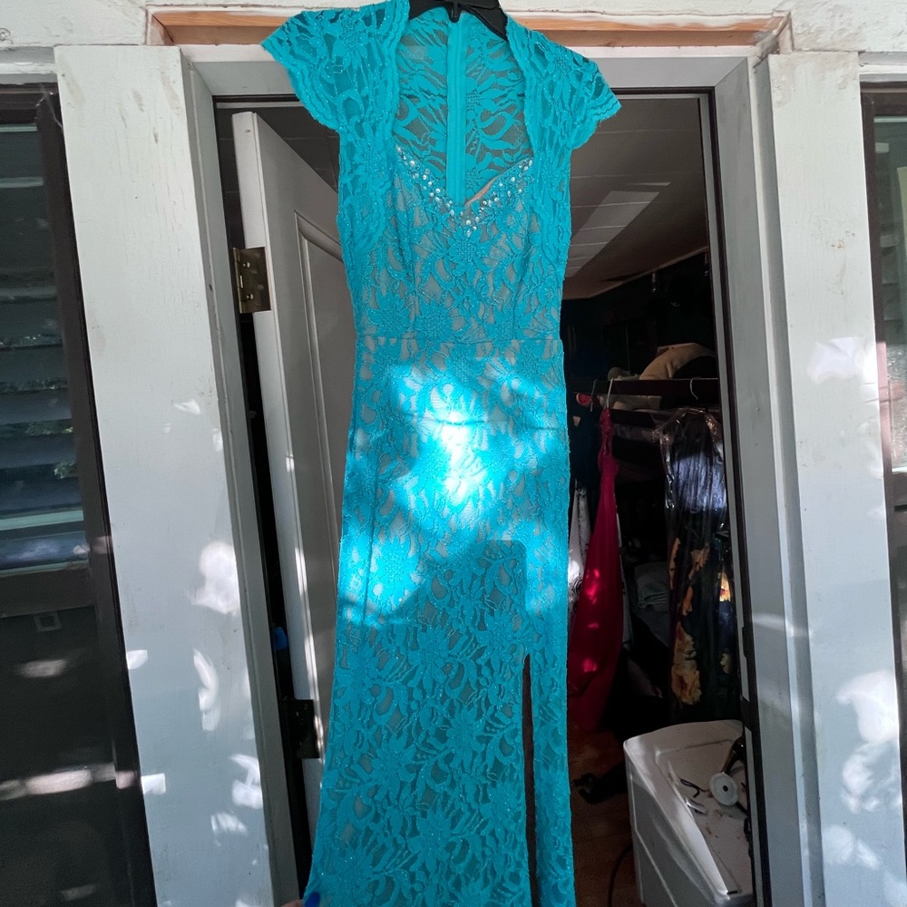 Lace cap sleeve prom dress with leg slit.